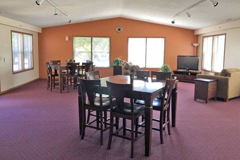 A dining room with a table and chairs.