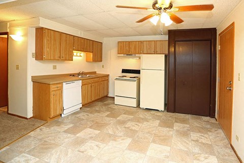 A kitchen with a white refrigerator, white dishwasher, and white oven.