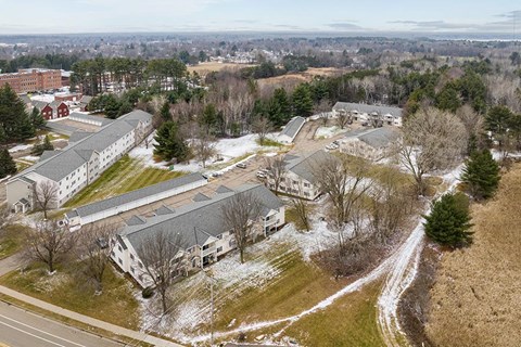 A large building complex with a snowy ground.