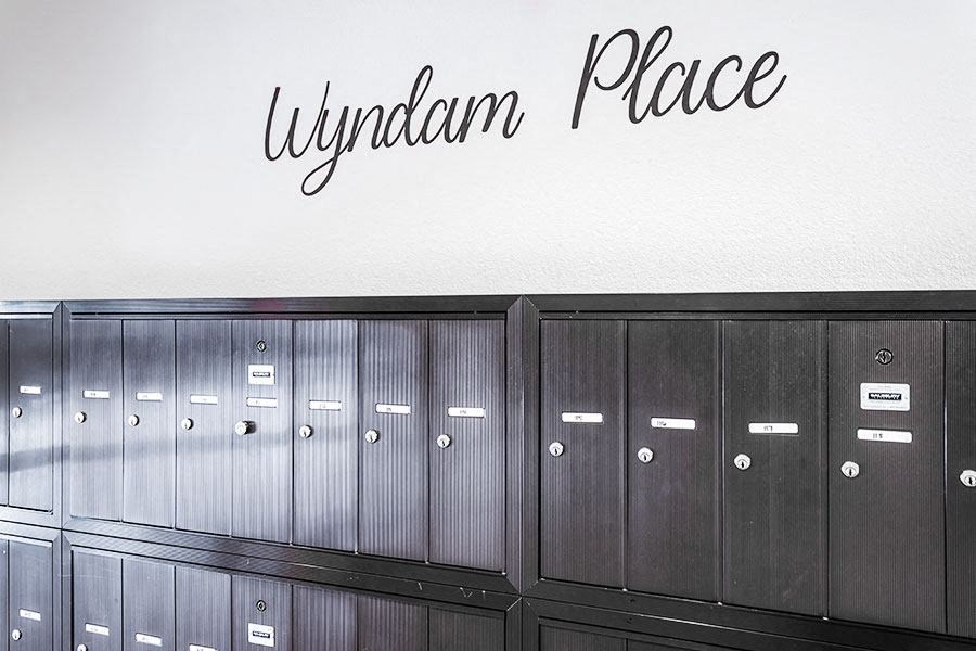 A row of lockers with a wall above them that says Wyndam Place.