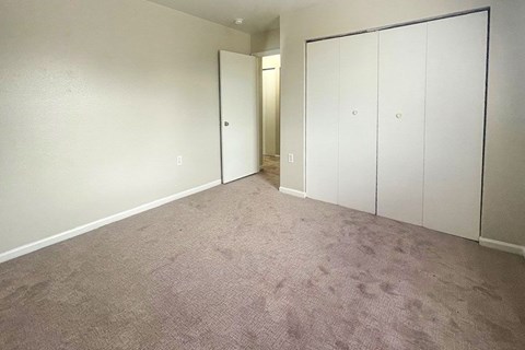A room with a carpeted floor and white walls.