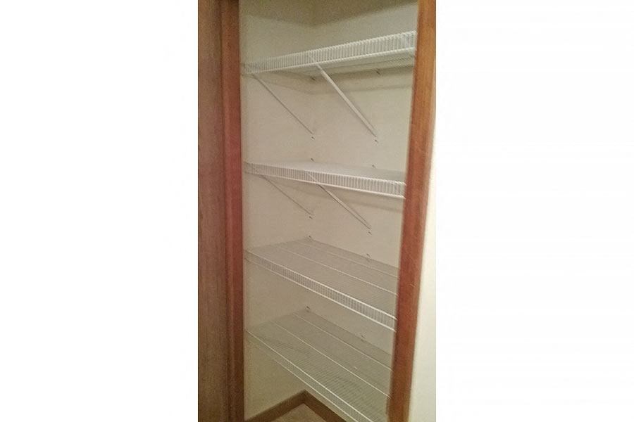 an empty closet with empty shelves in a closet