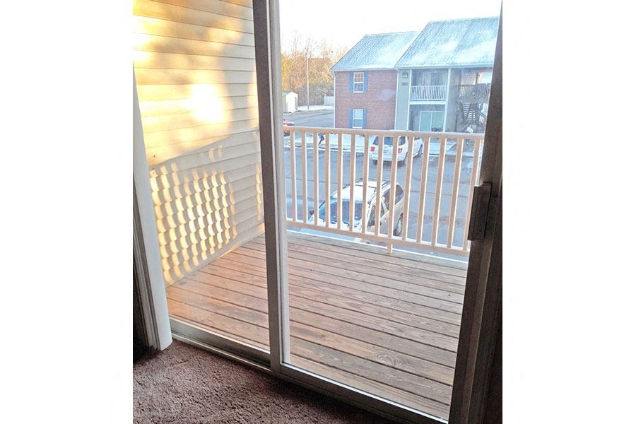 a sliding glass door with a view of a deck