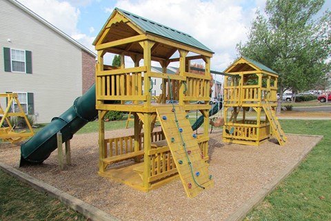 a playground with a swing set and a slide