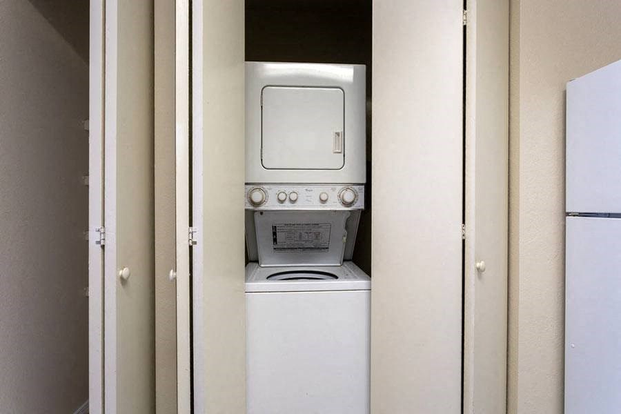 a white washer and dryer in a closet