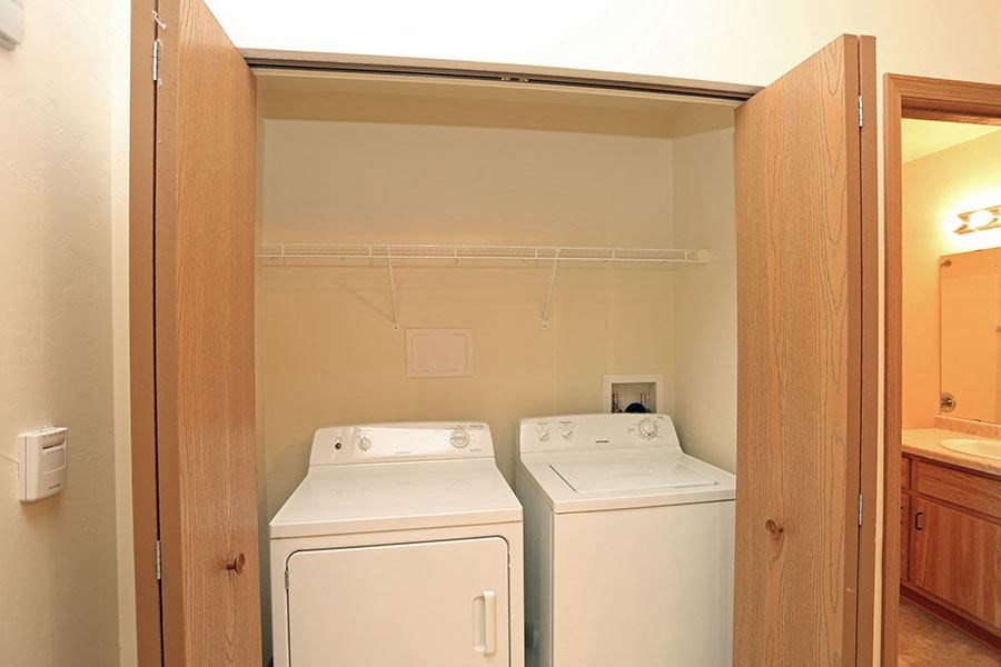 a room with two washes and a dryer in it