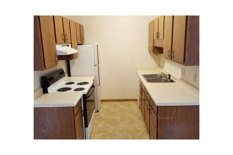 a kitchen with a stove and a refrigerator