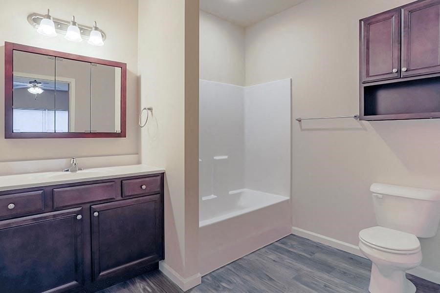 a bathroom with a toilet and a sink and a shower