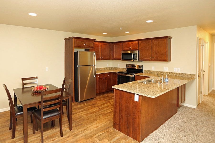a kitchen with stainless steel appliances and a table