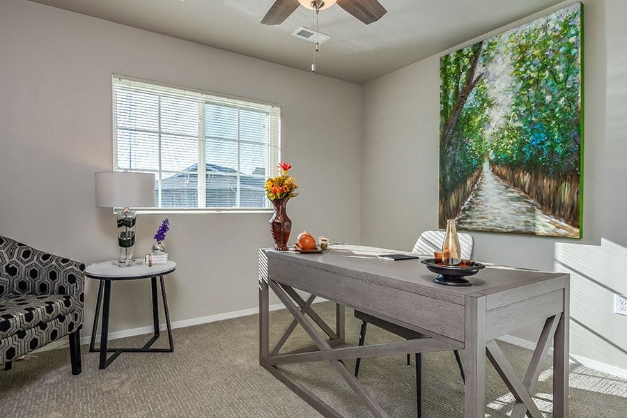 A dining room with a grey table and chairs.