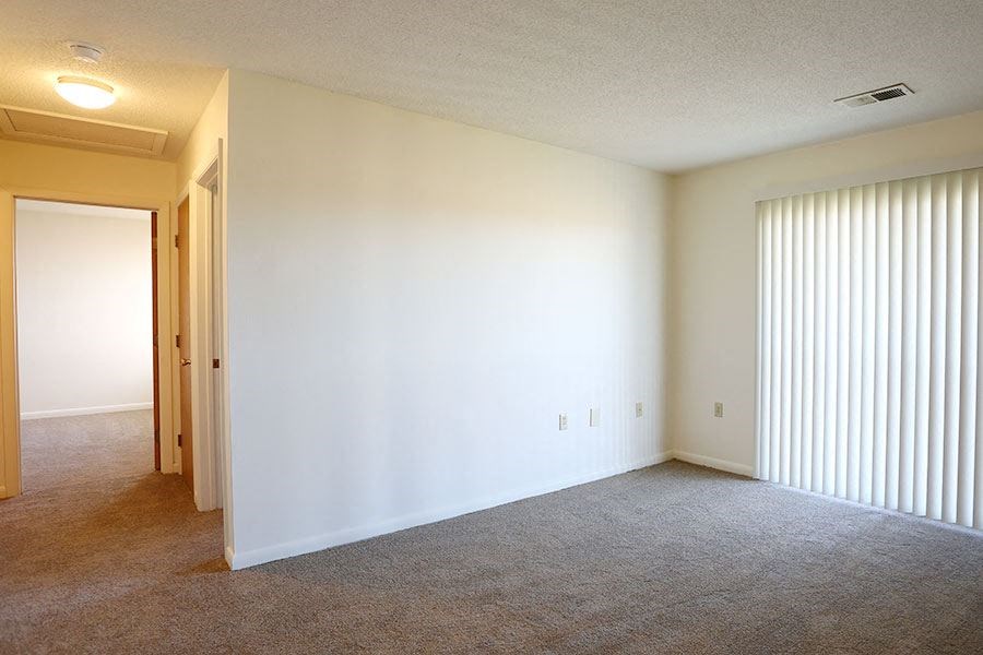 an empty living room with a large window
