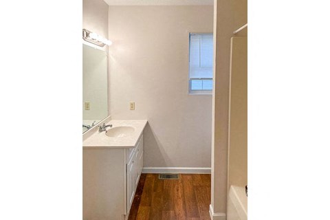 an empty bathroom with a sink and a mirror