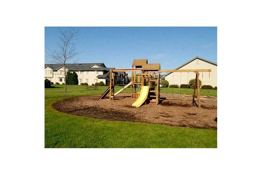 a playground with a swing set in a yard