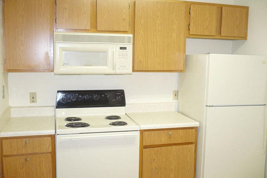 a kitchen with a white stove and a microwave