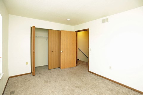 an empty room with three doors in it