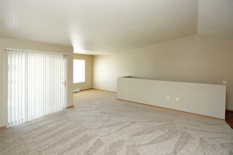 an empty living room with a sliding glass door