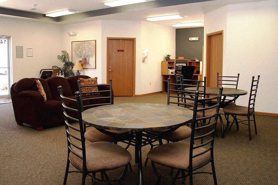 a living room with a round table and chairs