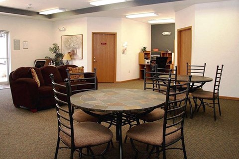a living room with a round table and chairs