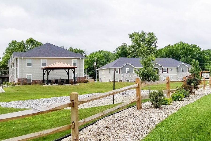 A house with a fence in front of it.