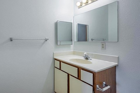 A bathroom with a sink and mirror.