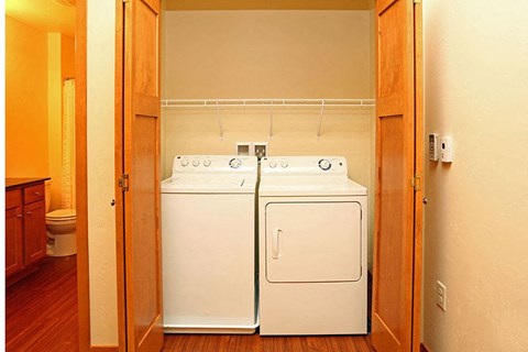 a white washer and dryer in a room with a door
