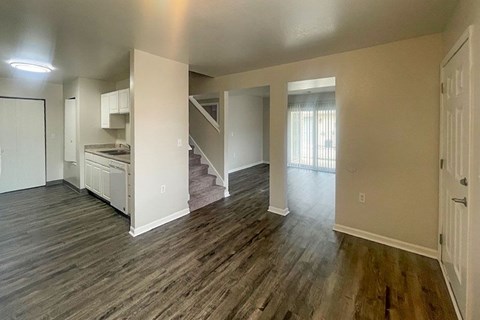 A room with wooden floors and white walls.