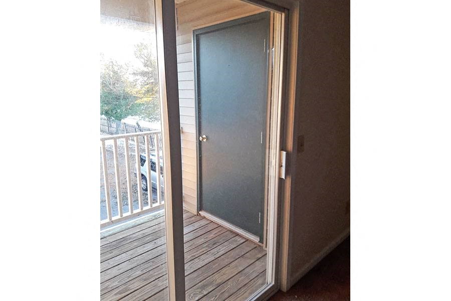 a patio door is open to a balcony