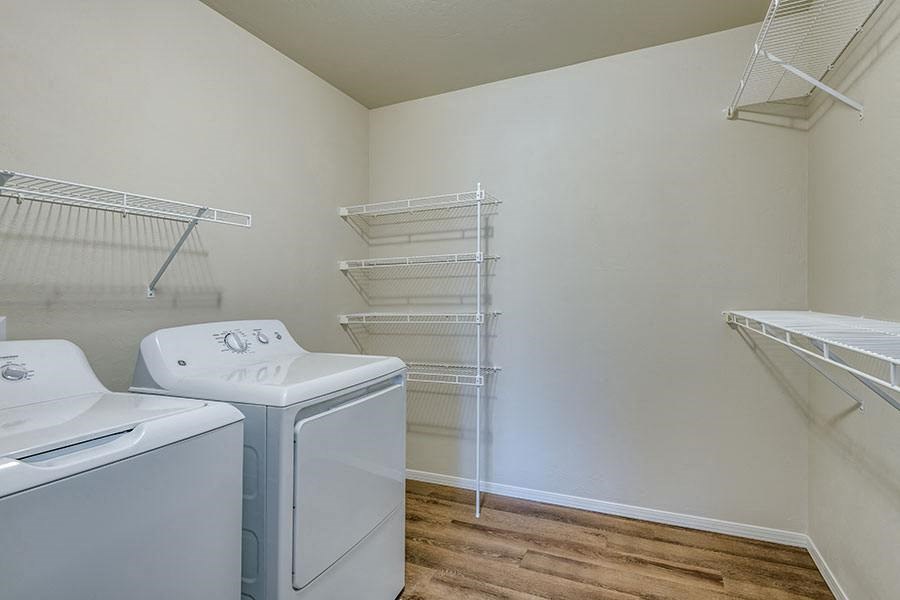 a laundry room with two washes and a dryer