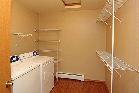 a white washer and dryer in a room with a closet
