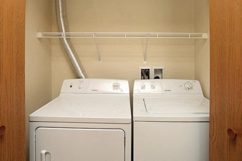 two white washers and dryers in a laundry room