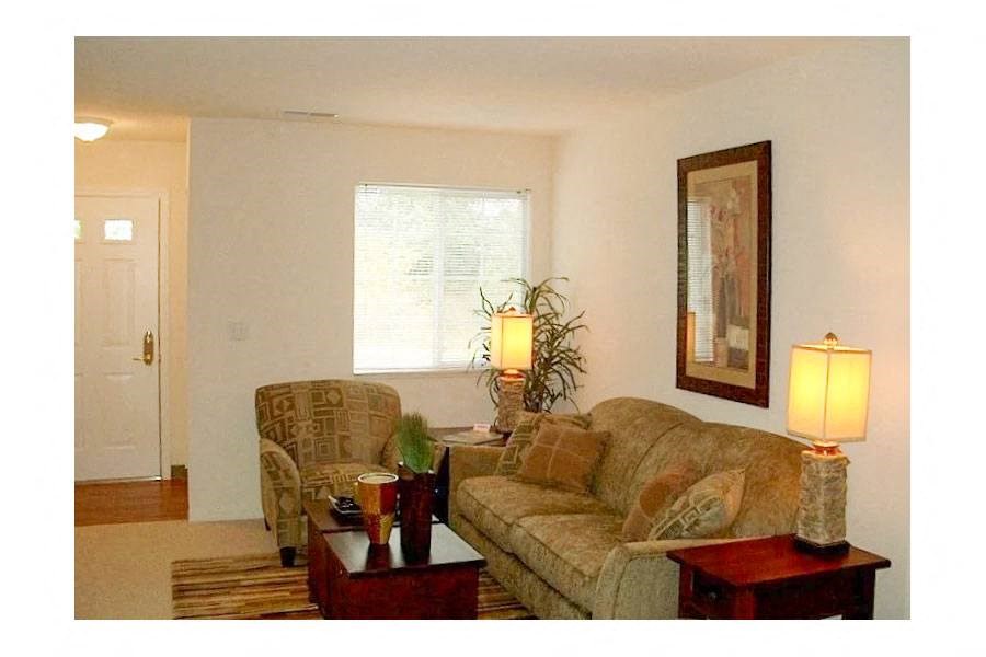 a living room with a couch and two lamps