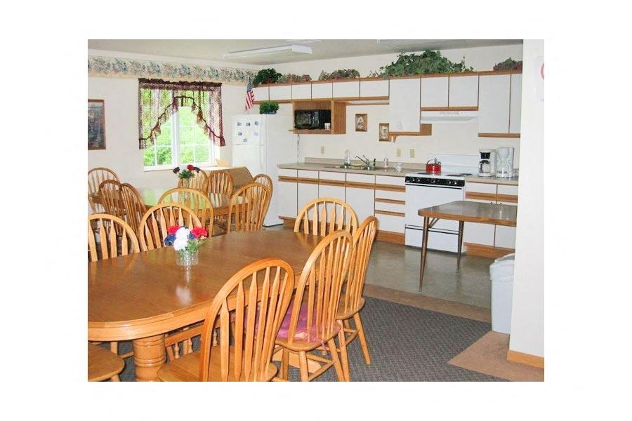 a kitchen with a wooden table and chairs