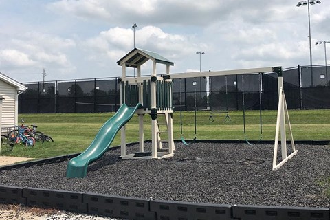 a childrens playground with a slide