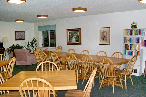 a dining room with wooden tables and chairs