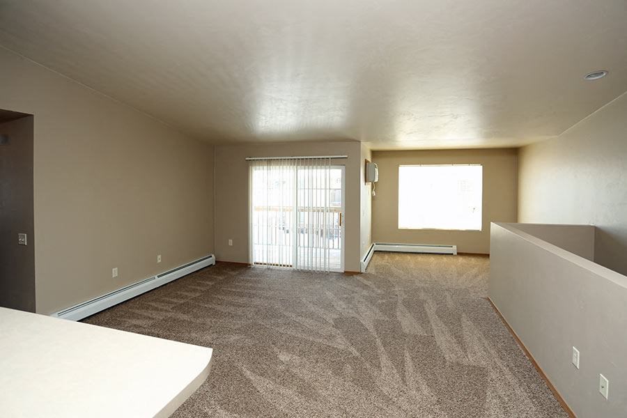 an empty living room with a sliding glass door