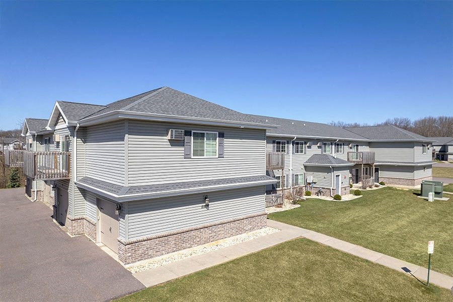 a white house with a porch and a yard