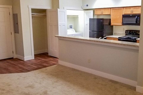 A kitchen area with a refrigerator, microwave, and oven.