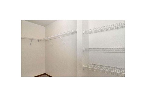 Empty white shelves in a room.