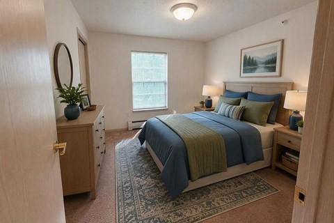 A bedroom with a bed, nightstands, and a rug.