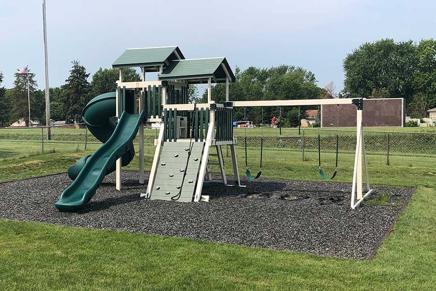 a playground with a slide and a swing set