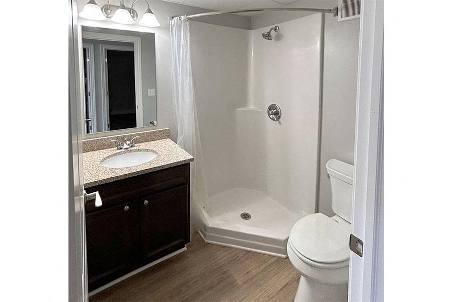 a bathroom with a toilet and a sink and a shower