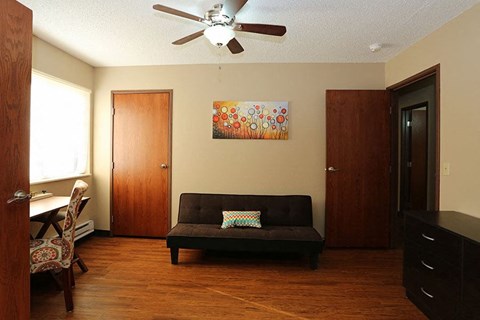 A living room with a couch, chair, and painting.