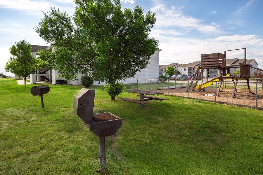 A playground with a slide and a swing set.