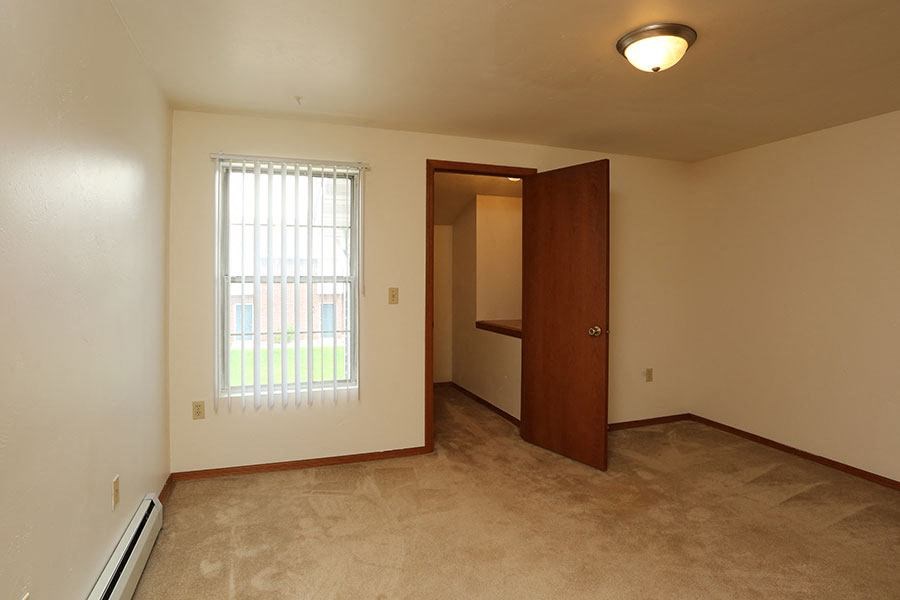 A room with a window and a door.