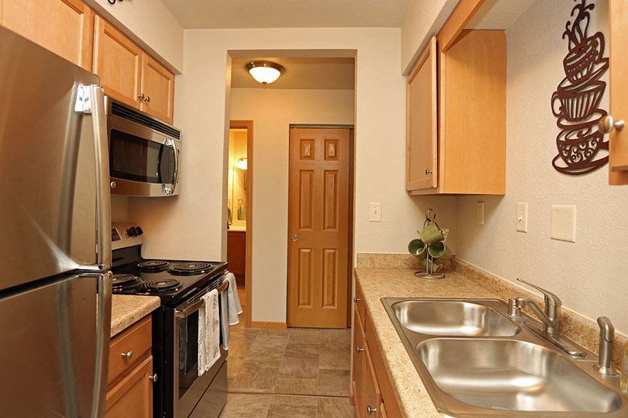 a kitchen with a sink and a stove and a refrigerator