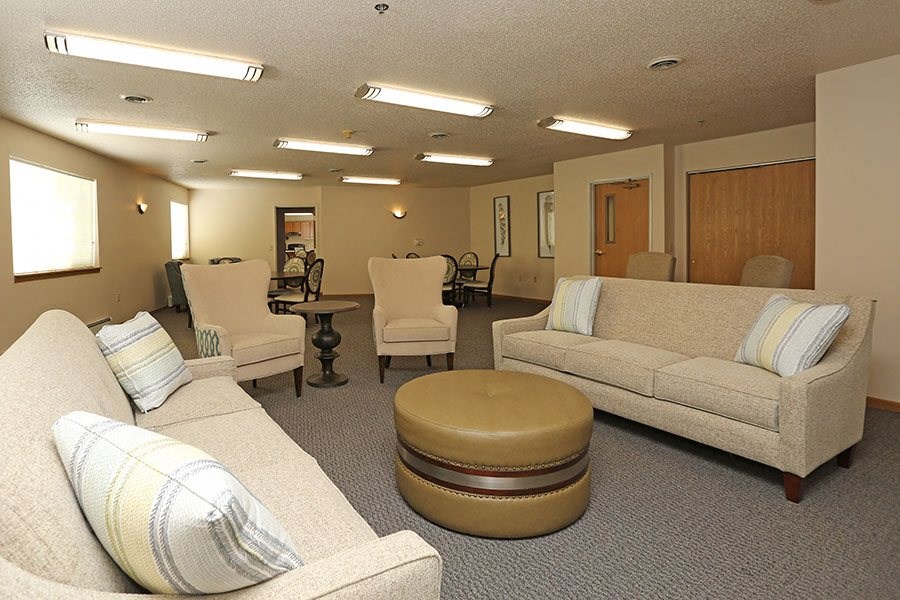 a living room with couches and chairs and a table