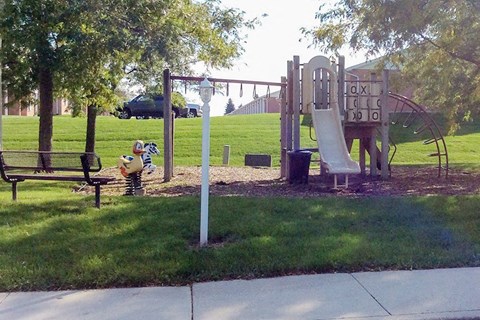 a park with a playground and a swing set