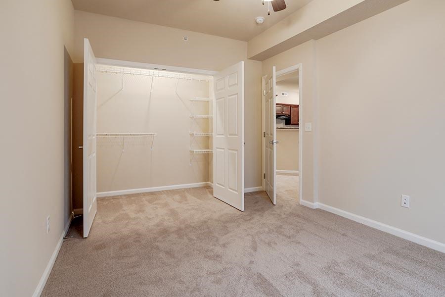 an empty room with a closet and a bathroom