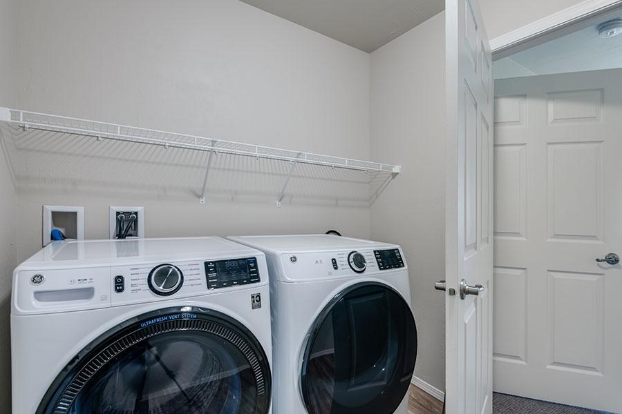 Two front load washing machines in a laundry room.