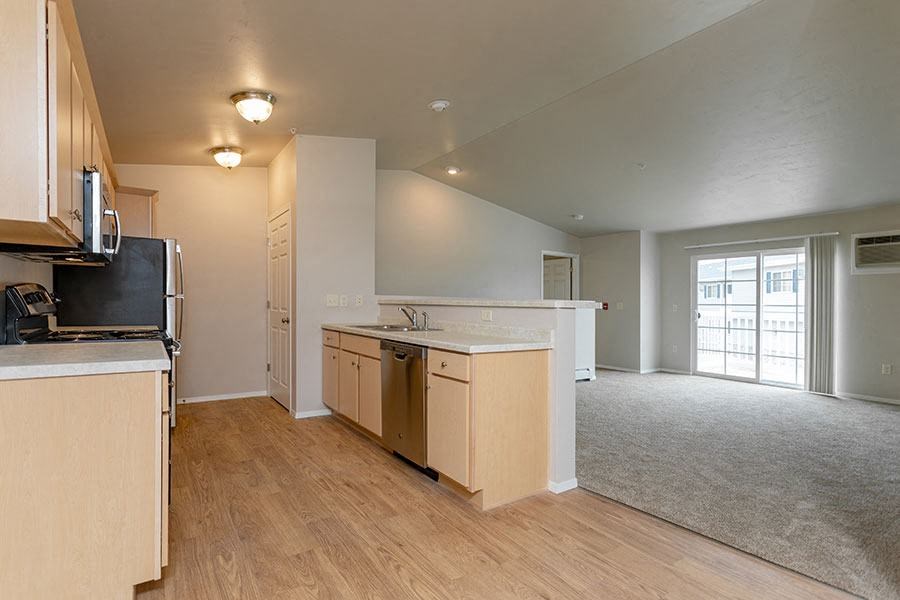 an empty kitchen with a stove and a sink
